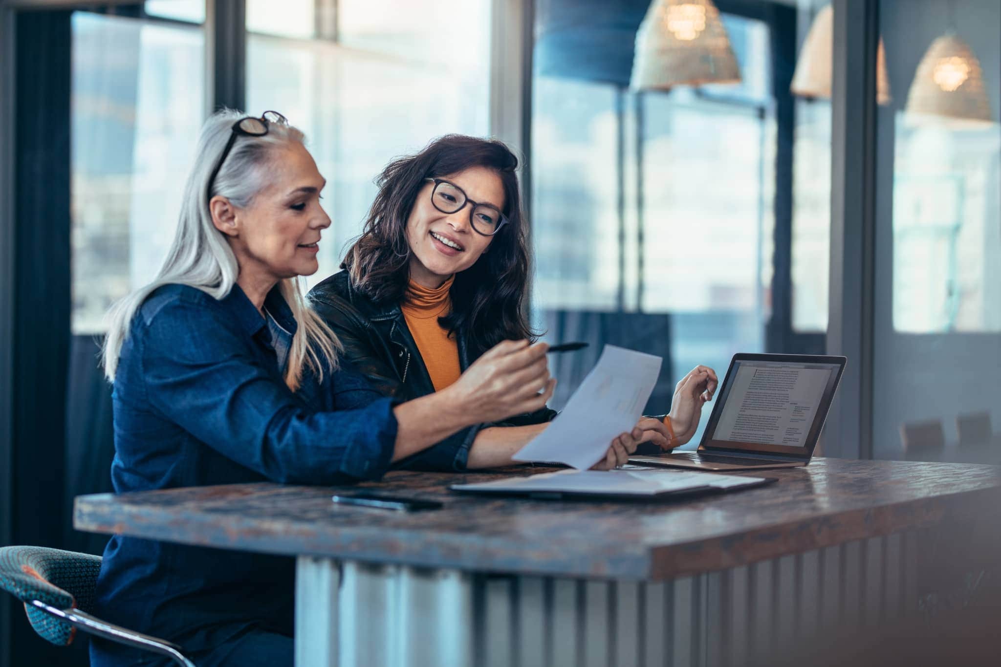 Two female coworkers brainstorming - Pearson TalentLens