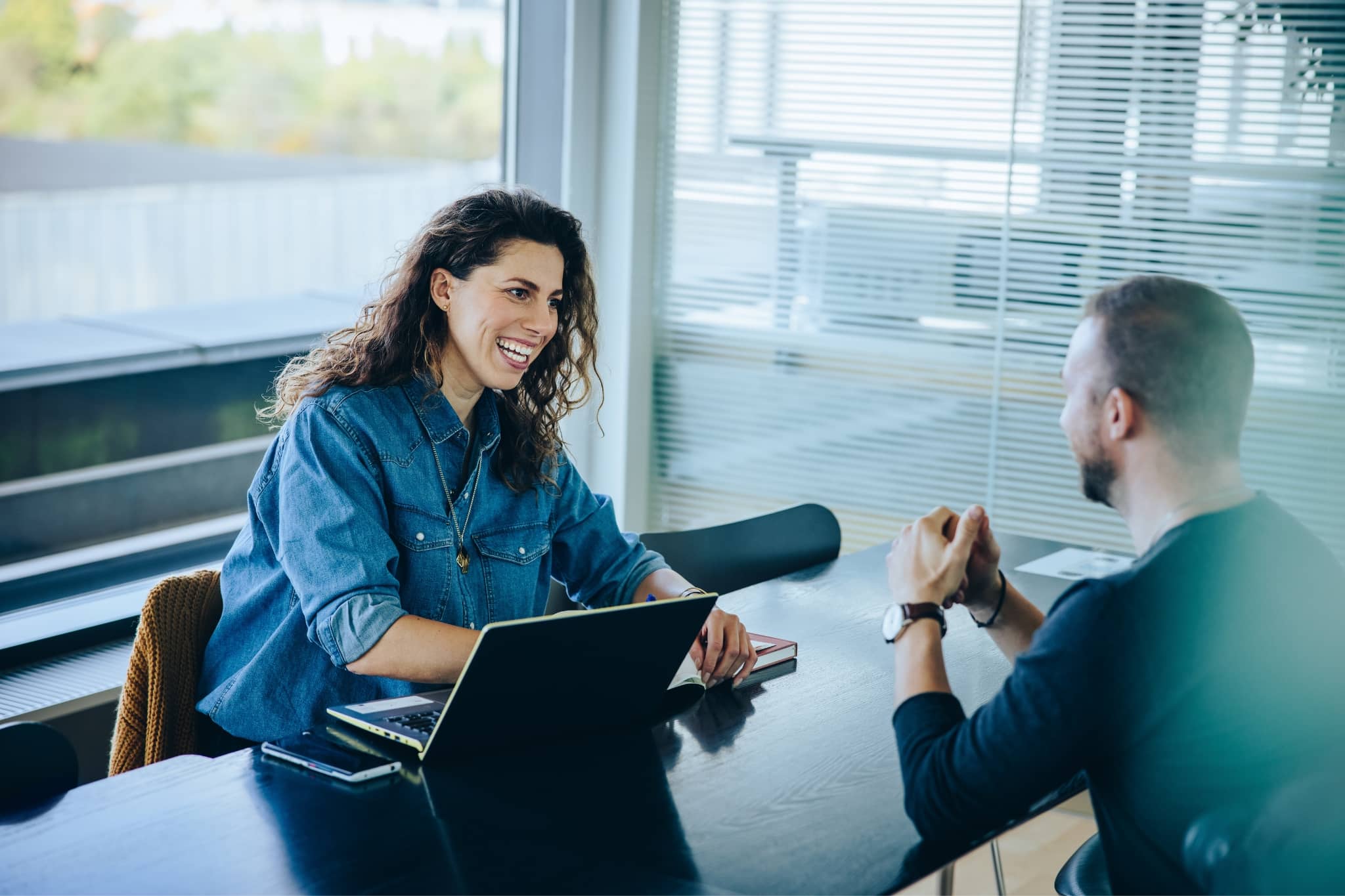 Two workers discussing at work - Pearson TalentLens