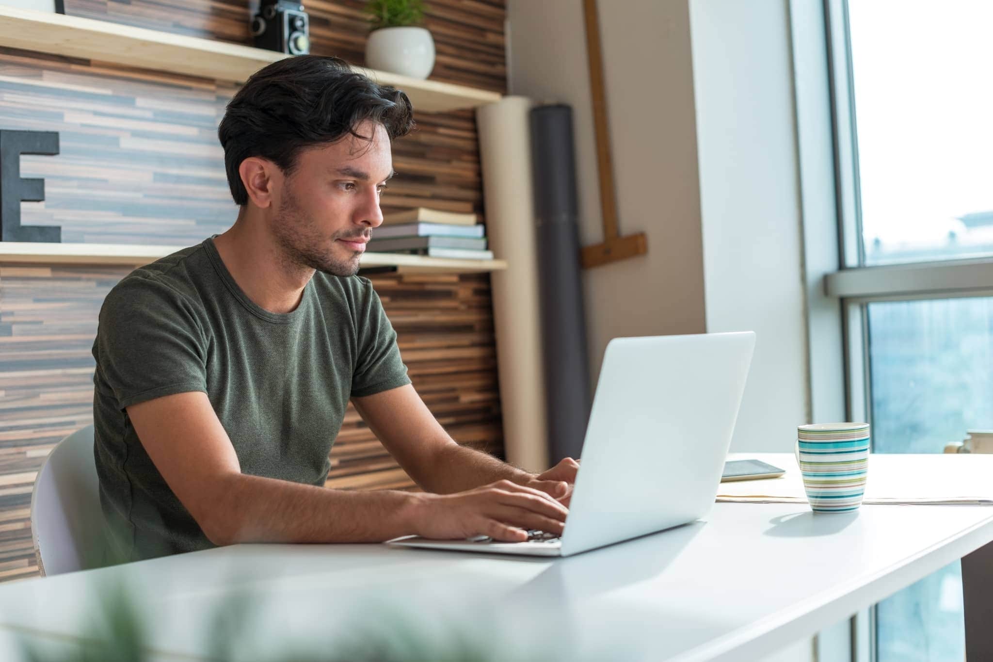 A male worker on his computer - Pearson TalentLens