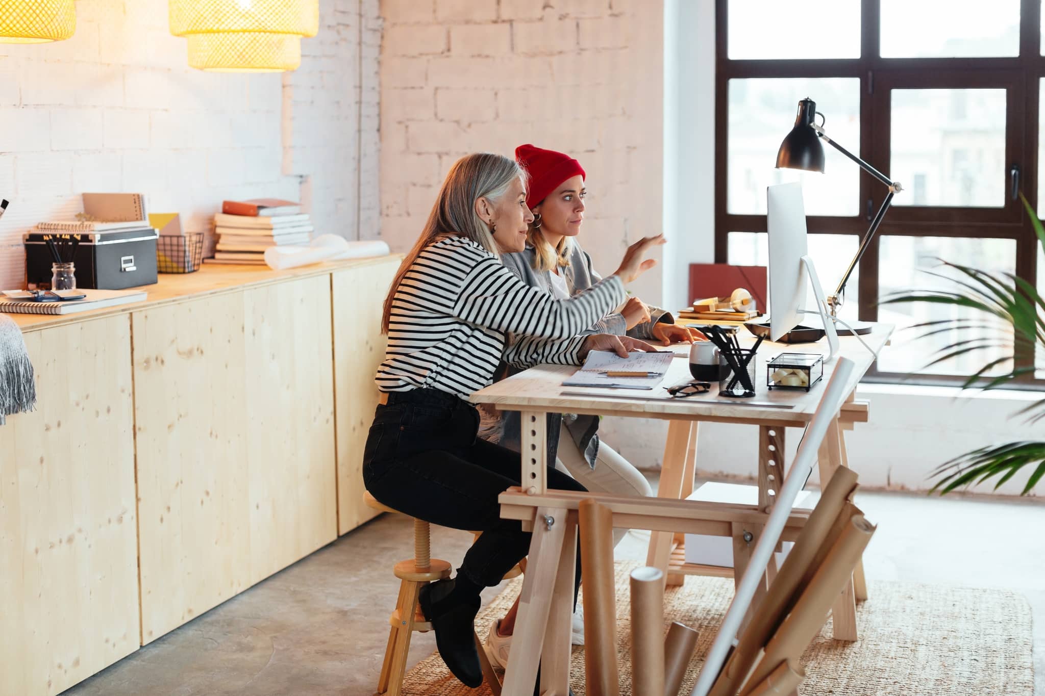 A manager and her team worker brainstorming - Pearson TalentLens
