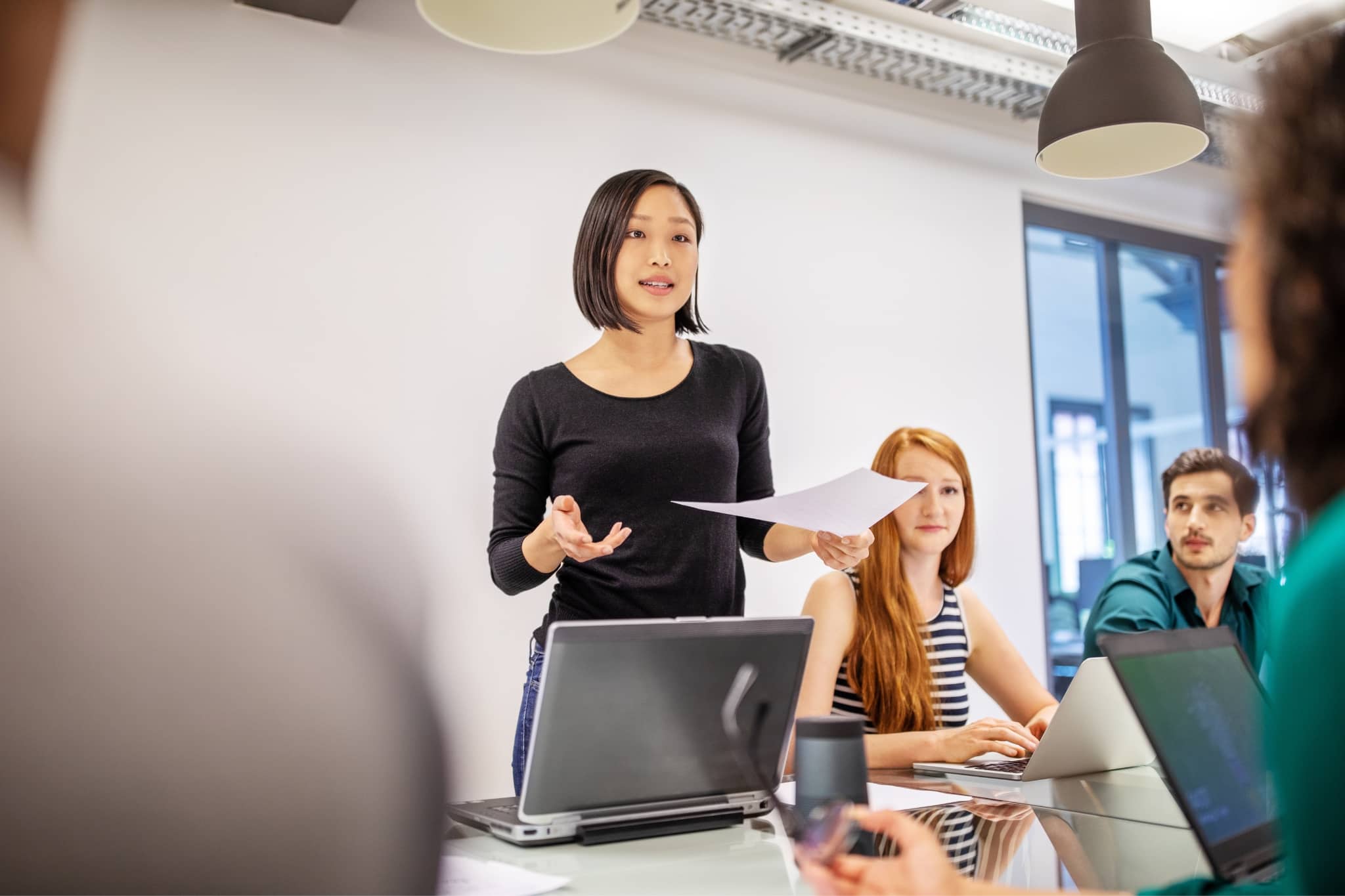 A woman leading a meeting with her team -Pearson TalentLens