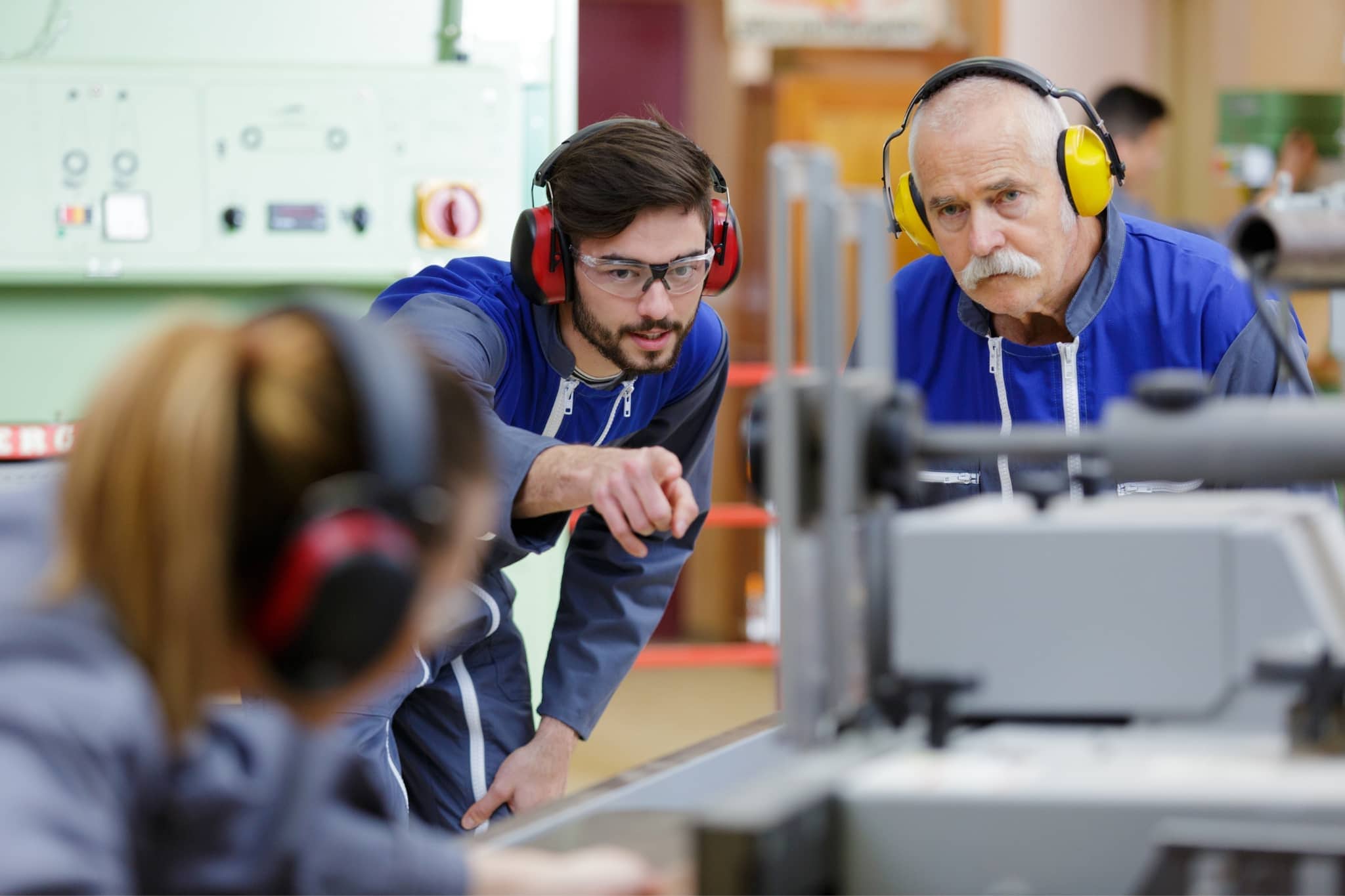 A group of coworkers in a factory working - Pearson TalentLens