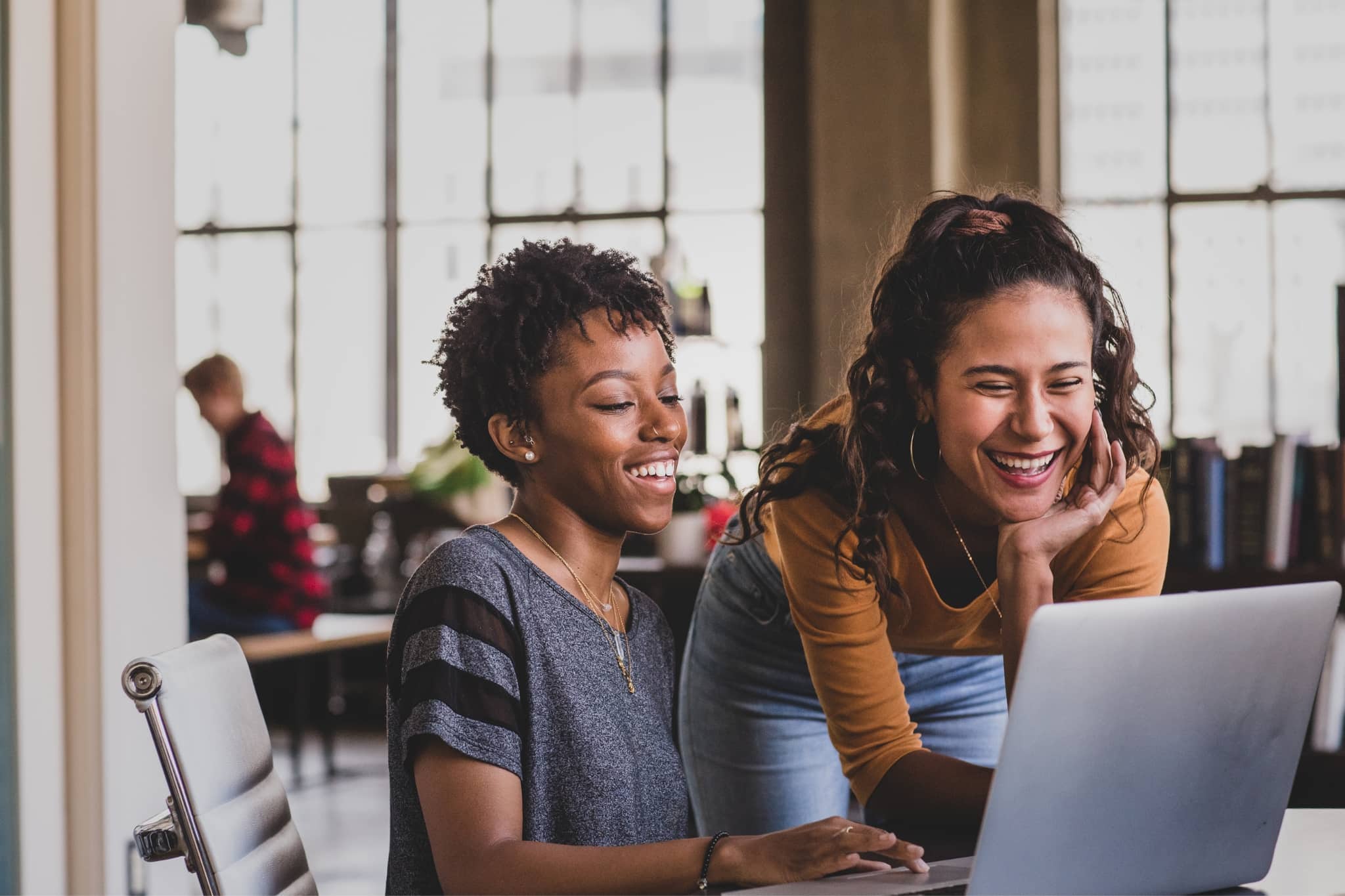 Two female coworkers brainstorming - Pearson TalentLens