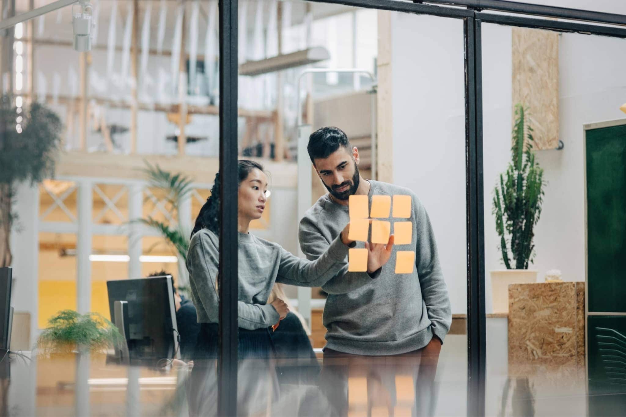 Two workers discussing at work - Pearson TalentLens