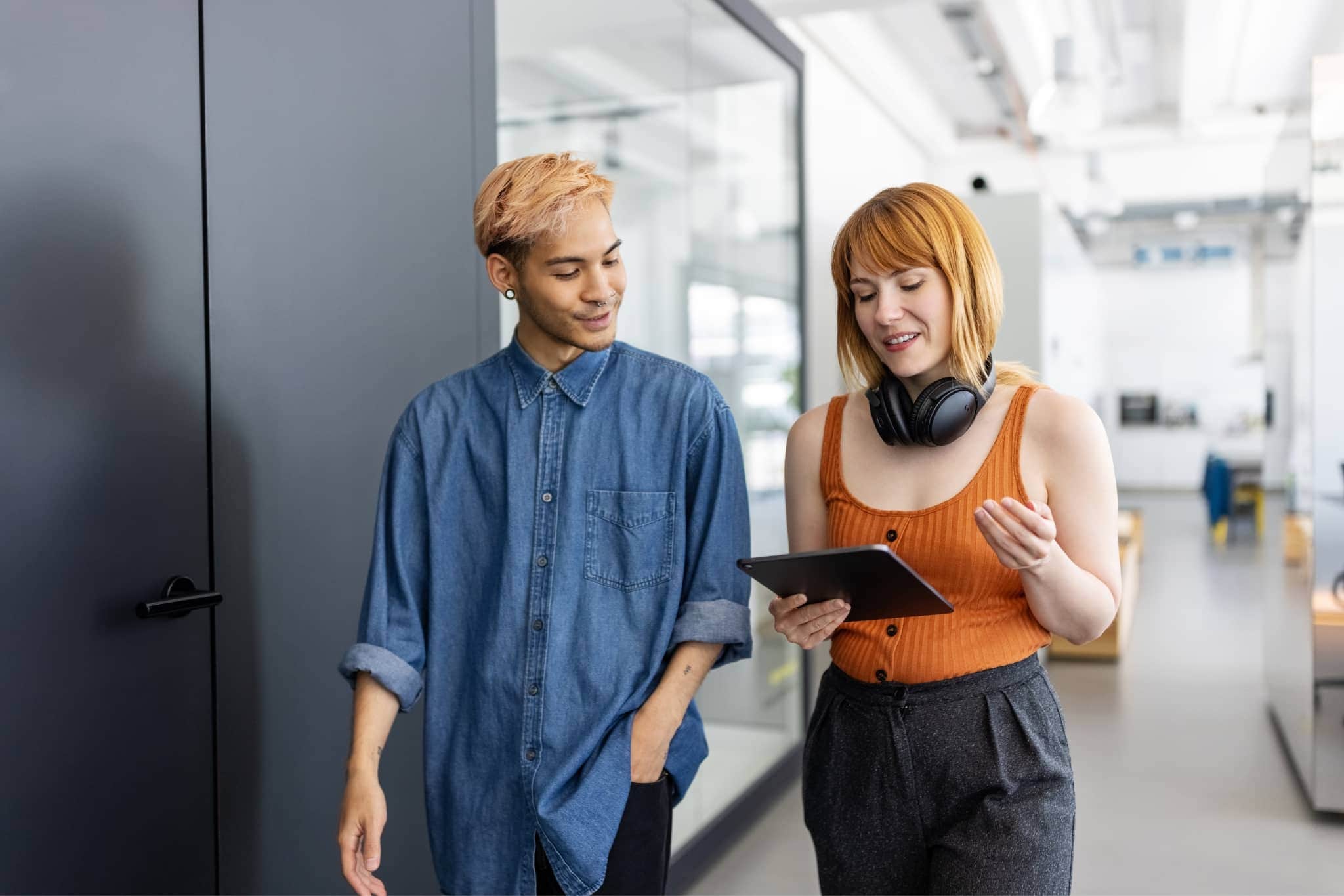 Two workers discussing at work - Pearson TalentLens