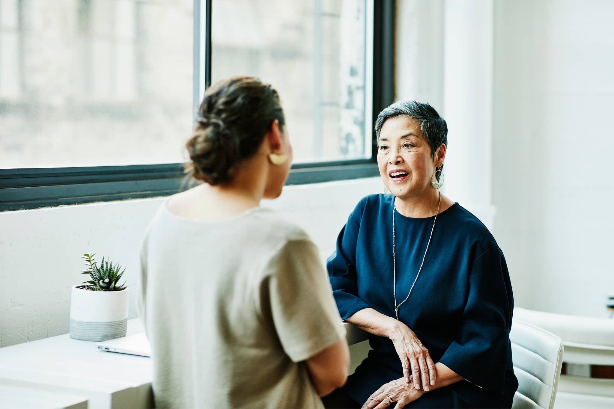 Two female coworkers brainstorming - Pearson TalentLens