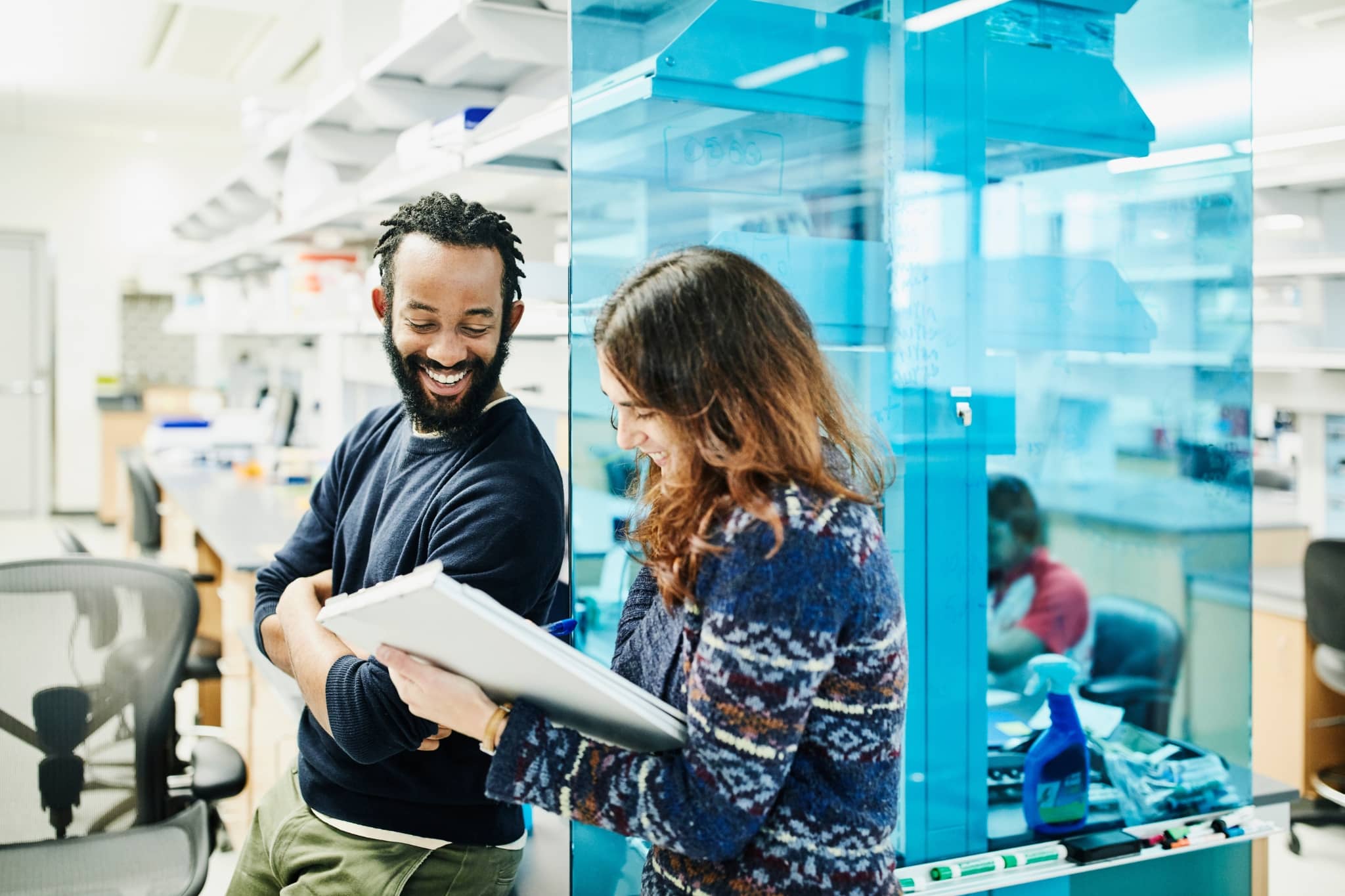 Two workers discussing at work - Pearson TalentLens