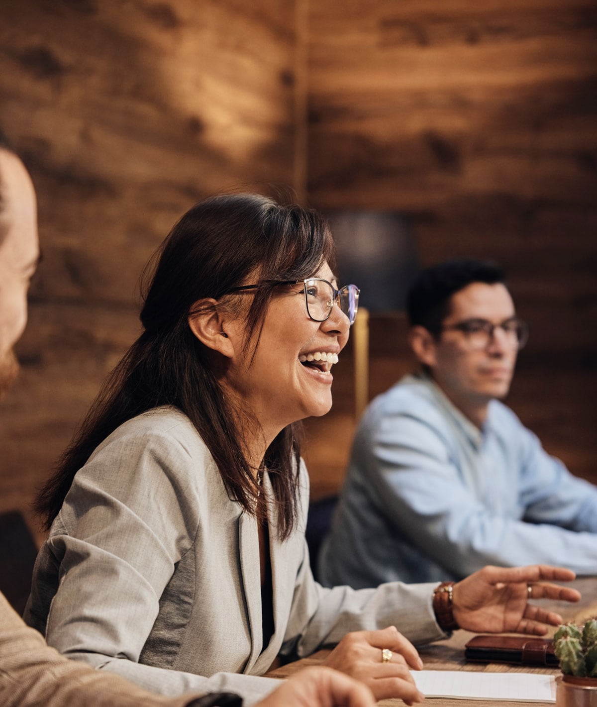 A woman laughing at work - Pearson TalentLens