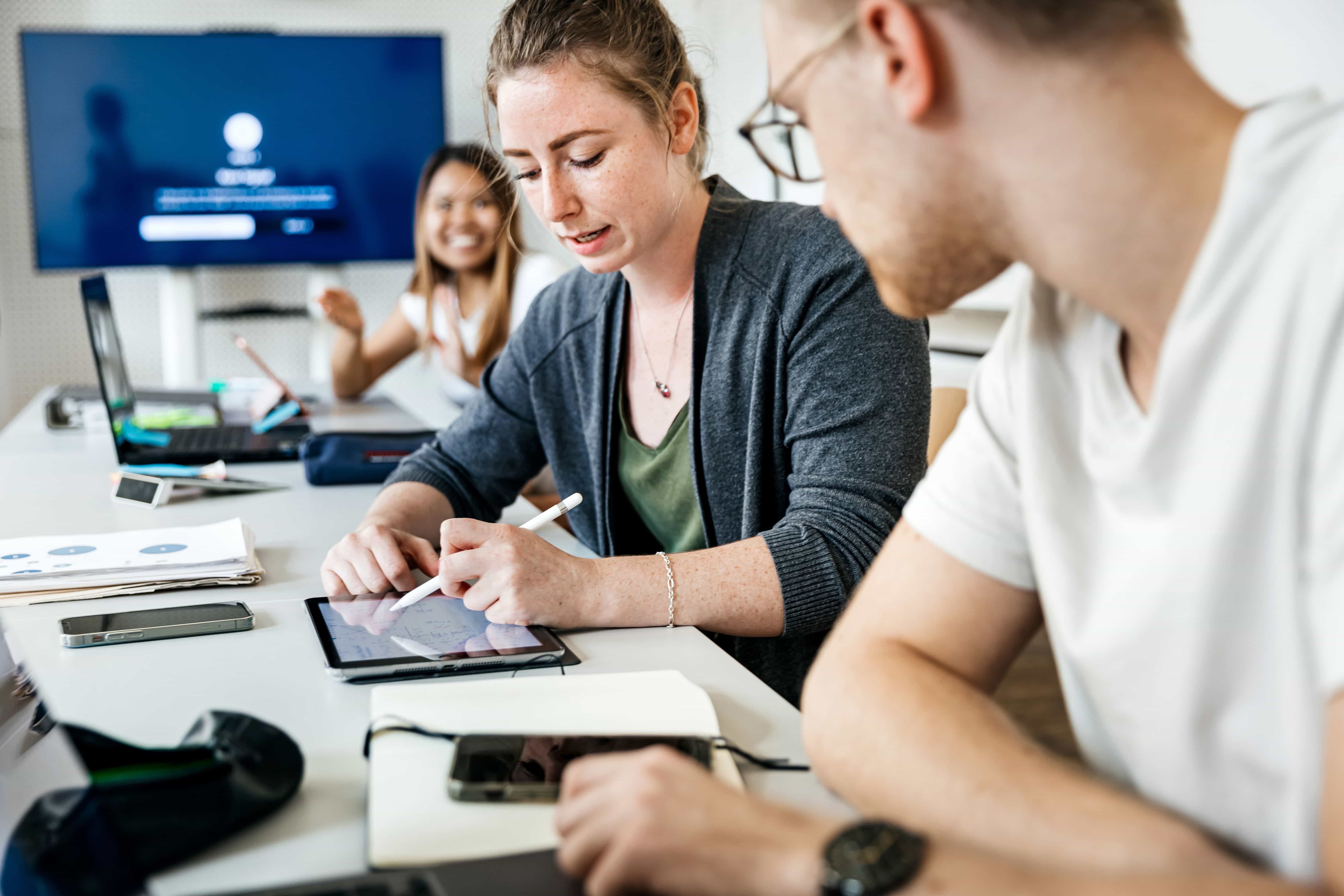 Two workers discussing at work - Pearson TalentLens