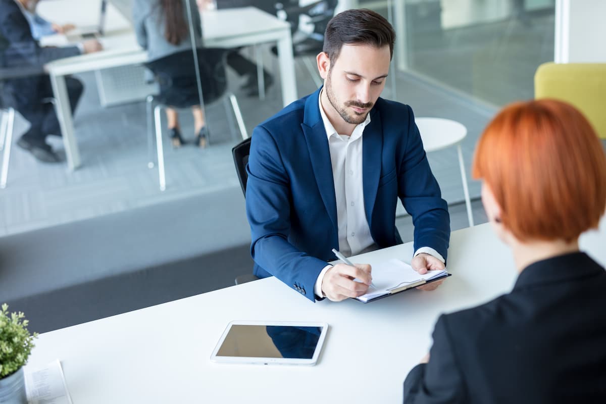Two workers discussing at work - Pearson TalentLens
