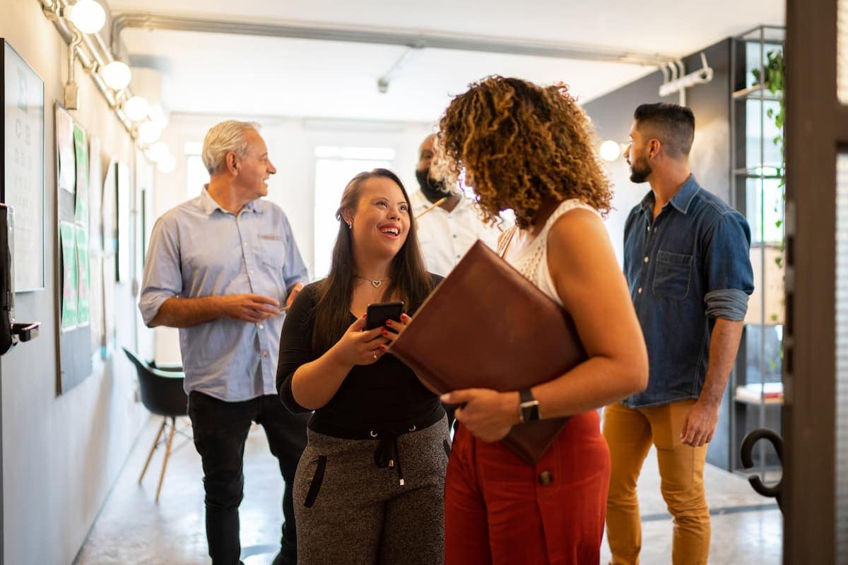 A group of team members discussing at the office - Pearson TalentLens