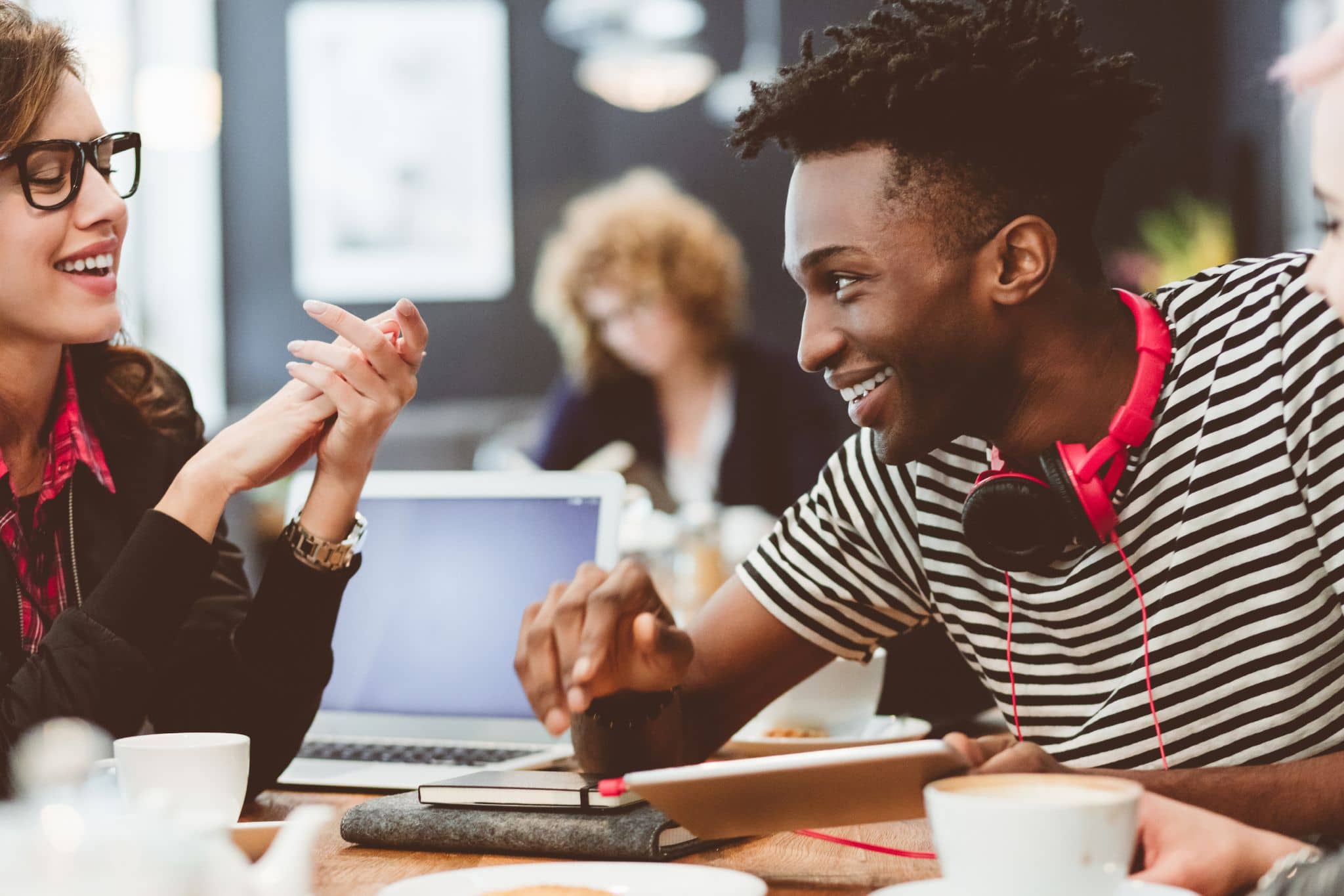 Group of young people sitting together in a casual setting - Pearson TalentLens