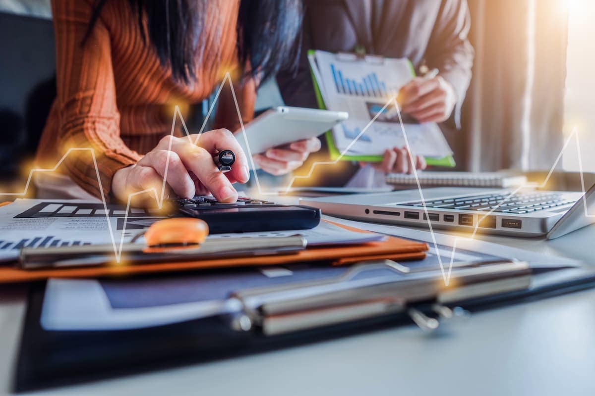 Close up photo of business partners using laptop and calculator